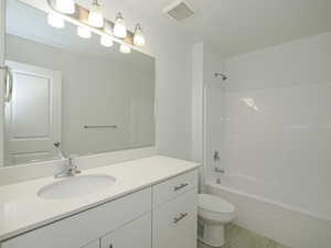 Full bathroom featuring vanity, shower / washtub combination, and toilet