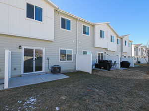 Rear view of house featuring a patio and central air condition unit