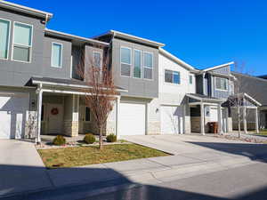 Townhome / multi-family property featuring a garage