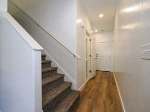 Stairway featuring hardwood / wood-style flooring