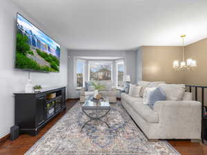 Living room with dark hardwood / wood-style flooring and large window