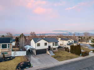 View of front of home with a garage, a yard, RV parking with an included carport cover