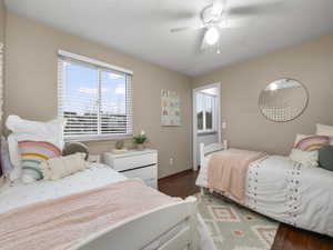 2nd bedroom featuring ceiling fan and dark hardwood / wood-style flooring