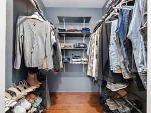 Walk in closet featuring dark hardwood / wood-style floors