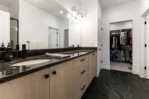 Bathroom featuring vanity and a shower with shower door