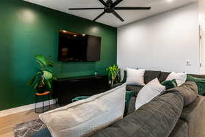 Living room featuring hardwood / wood-style flooring and ceiling fan