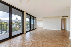 Expanded living room with floor-to-ceiling windows.