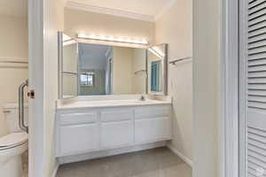 Master Suite #1 Bathroom with crown molding, vanity, and toilet