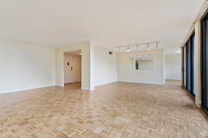 Empty room featuring light parquet floors