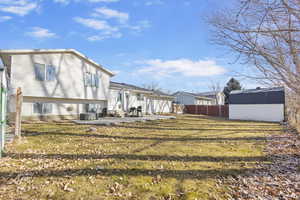 Rear view of property featuring concrete slab.