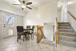 Bright dining area leading upstairs and to lower level.