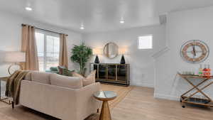 Living room with light hardwood / wood-style flooring