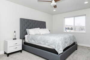 Bedroom featuring light carpet and ceiling fan