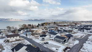 Snowy aerial view with a water and mountain view