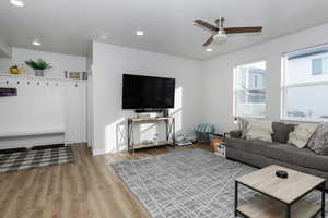 Living room featuring ceiling fan and light hardwood / wood-style floors