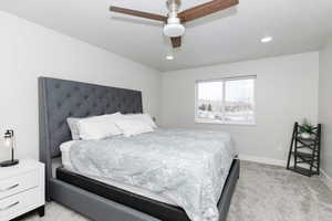 Carpeted bedroom with ceiling fan