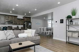 Living room with hardwood / wood-style flooring and a textured ceiling