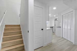 Stairs featuring hardwood / wood-style floors