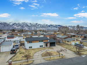 View of front of property with a garage and a mountain view