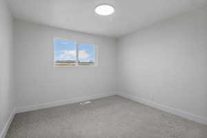 Spare room with carpet flooring