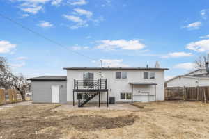 Rear view of house with a wooden deck and central AC unit