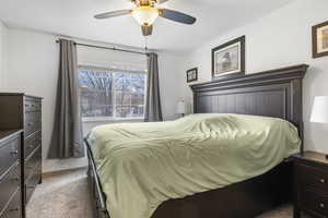 Bedroom featuring ceiling fan and carpet floors