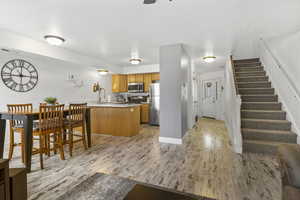 Kitchen featuring stainless steel appliances, kitchen peninsula, and light wood-type flooring