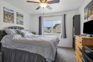 Carpeted bedroom with ceiling fan