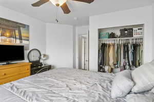 Bedroom with ceiling fan and a closet