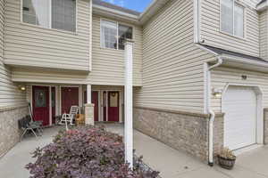 View of exterior entry featuring a garage