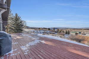 Wooden terrace with grilling area and a mountain view