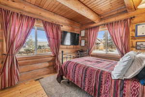 Bedroom featuring wood ceiling, beam ceiling, and hardwood / wood-style flooring