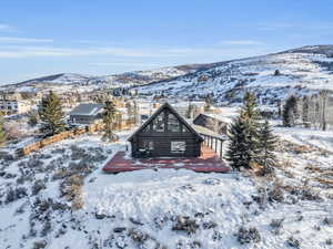 Snow covered back of property featuring a mountain view