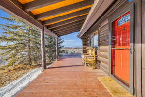 View of patio with a wooden deck