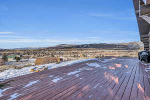 Wooden terrace featuring a mountain view