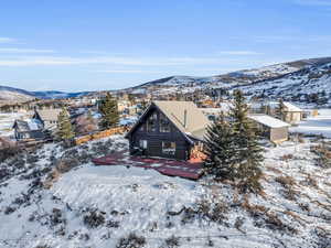 Snowy aerial view featuring a mountain view