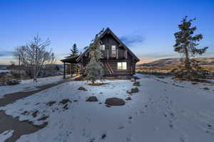 View of front of property featuring a balcony and a mountain view