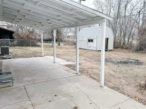 View of patio with central AC and a storage unit