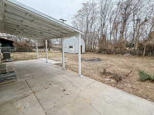 View of patio / terrace featuring a shed