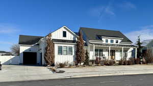 Modern inspired farmhouse with a garage and covered porch