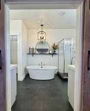 Bathroom with vanity, independent shower and bath, and a chandelier