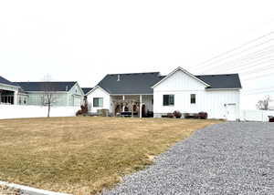 Rear view of property featuring a yard