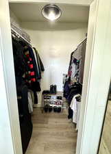 Walk in closet featuring hardwood / wood-style floors