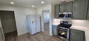 Kitchen featuring backsplash, stainless steel appliances, and light hardwood / wood-style floors