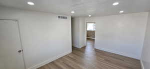 Spare room featuring light wood-type flooring