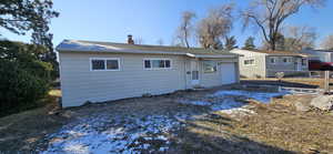 Rear view of property featuring a garage