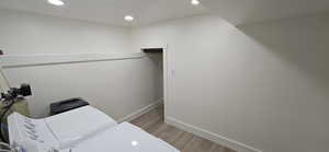 Laundry room featuring independent washer and dryer and light hardwood / wood-style flooring