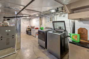 Laundry area with separate washer and dryer and heating unit