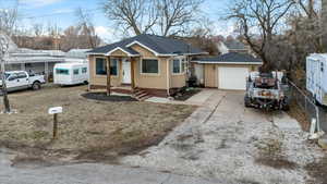 Single story home with a garage and a carport