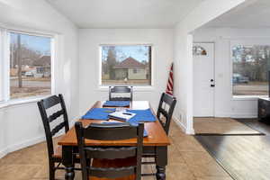 Dining space featuring plenty of natural light and light tile patterned floors